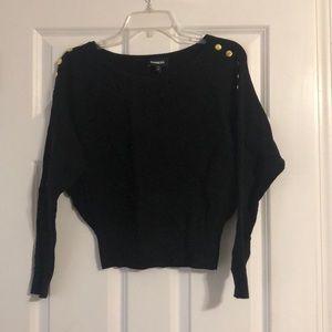 Black express crop sweater with gold buttons.